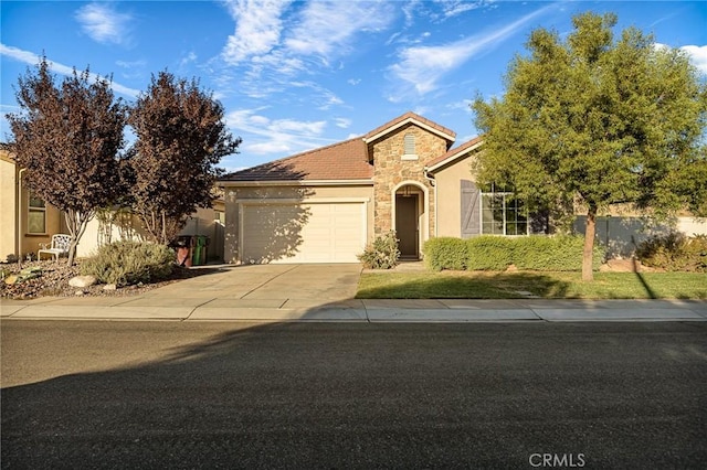 view of front of property featuring stucco siding, an attached garage, stone siding, driveway, and a tiled roof