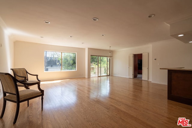 sitting room featuring light hardwood / wood-style floors and ornamental molding