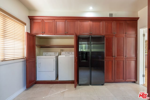 washroom featuring washing machine and clothes dryer and light tile patterned flooring