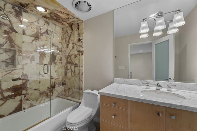 full bathroom featuring vanity, enclosed tub / shower combo, and toilet