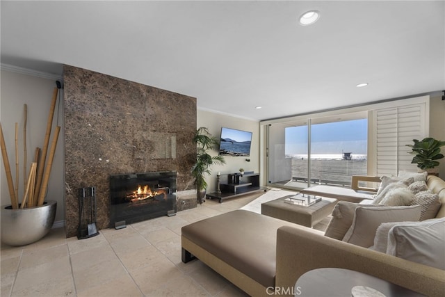 tiled living room featuring crown molding and a high end fireplace