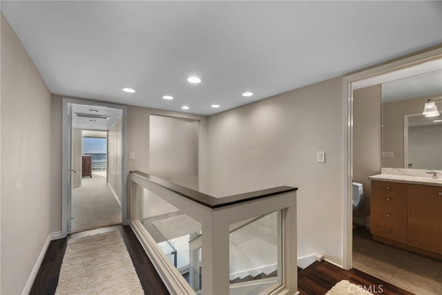 hall with dark hardwood / wood-style flooring and sink