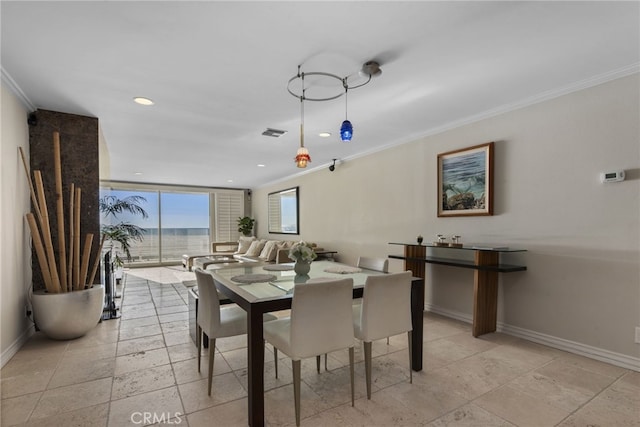 dining area featuring crown molding