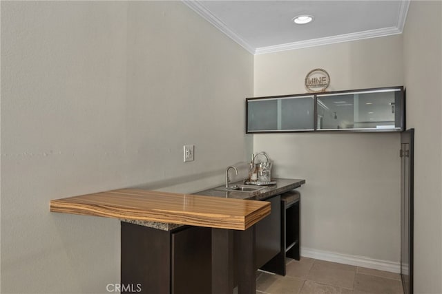 interior space featuring crown molding and indoor wet bar