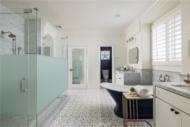 bathroom featuring vanity, toilet, an enclosed shower, and crown molding