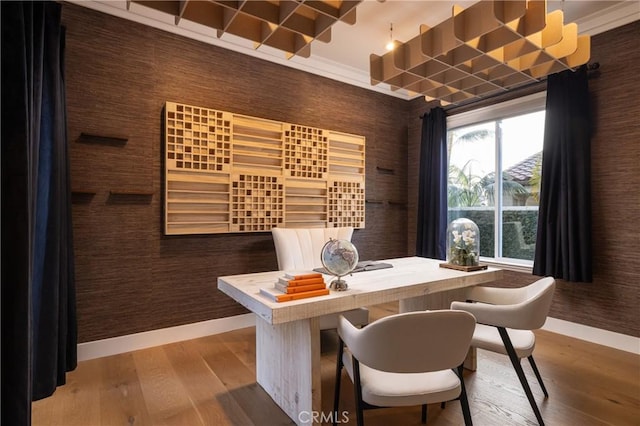 dining space with hardwood / wood-style flooring and wooden walls