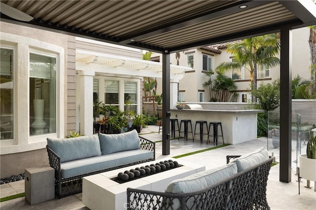 view of patio / terrace featuring exterior bar and an outdoor hangout area