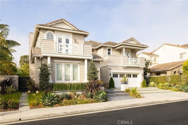 view of front of house featuring a balcony and a garage