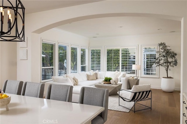 interior space featuring a notable chandelier, dark hardwood / wood-style flooring, and crown molding