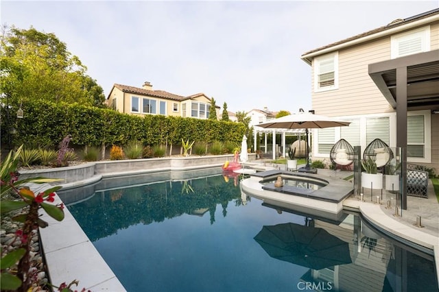 view of swimming pool with an in ground hot tub and a patio area