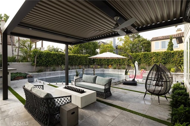 view of patio / terrace featuring a fenced in pool, an outdoor living space with a fire pit, and ceiling fan