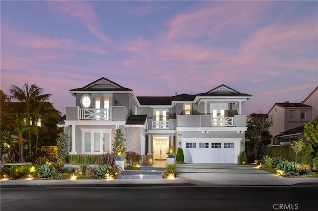 view of front facade featuring a garage and a balcony