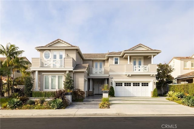 view of front of house featuring a balcony and a garage