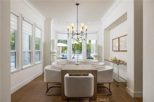 dining space with dark hardwood / wood-style flooring, ornamental molding, and a chandelier