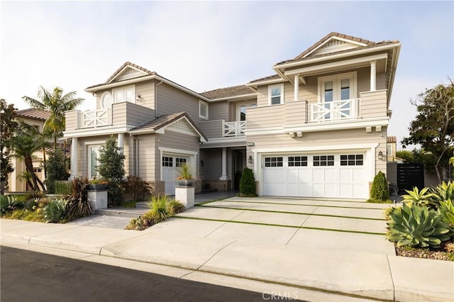 view of front of property featuring a garage and a balcony