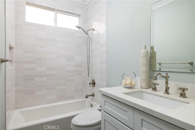 full bathroom with vanity, toilet, and tiled shower / bath