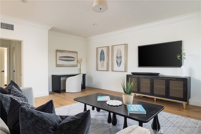 living room with crown molding and light hardwood / wood-style flooring