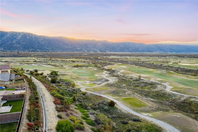 aerial view at dusk featuring a mountain view