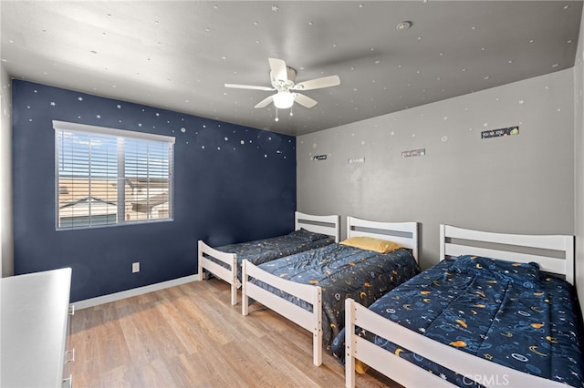 bedroom featuring baseboards and wood finished floors