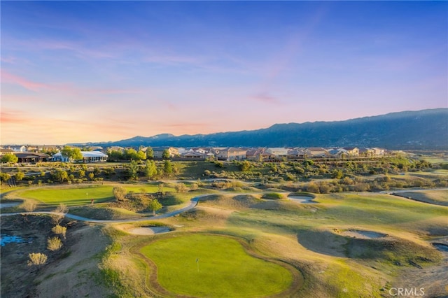 aerial view at dusk with a residential view, a mountain view, and golf course view