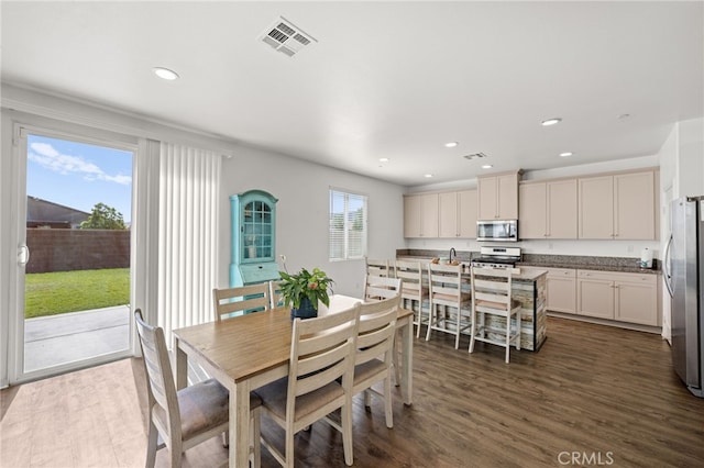 dining space featuring dark wood-style flooring, visible vents, and recessed lighting