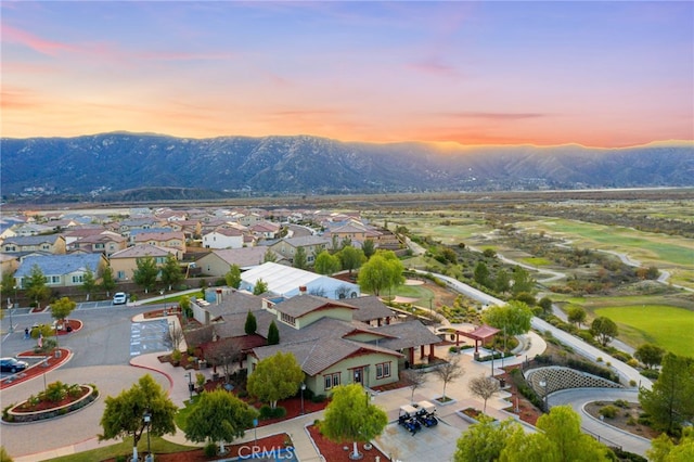 aerial view at dusk featuring a residential view and a mountain view