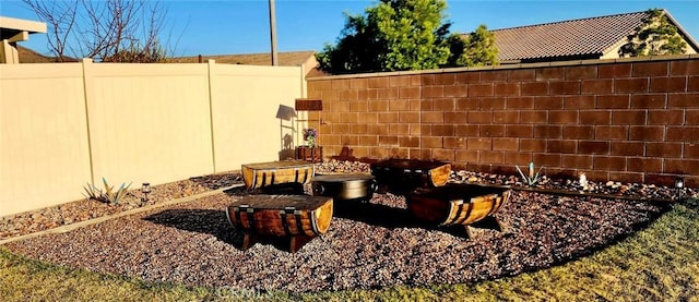 exterior space with a fire pit and fence