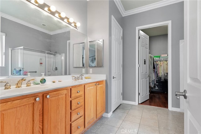 bathroom featuring walk in shower, vanity, crown molding, and tile patterned flooring