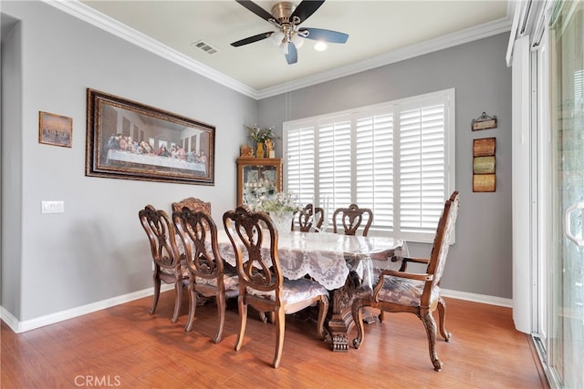 dining room featuring ceiling fan, crown molding, and hardwood / wood-style floors