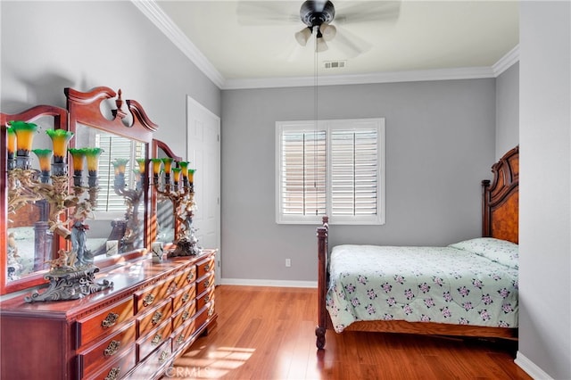 bedroom with light hardwood / wood-style floors, ornamental molding, and ceiling fan