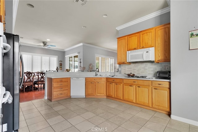 kitchen featuring ceiling fan, light tile patterned flooring, ornamental molding, and white appliances