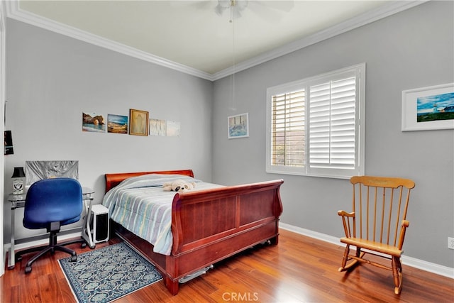 bedroom with ceiling fan, hardwood / wood-style flooring, and crown molding