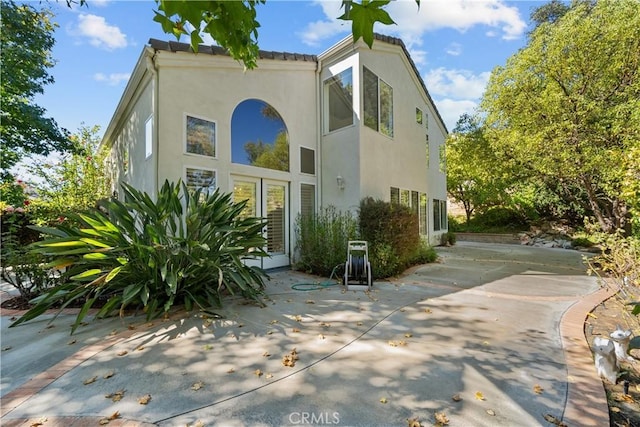 view of property exterior with a patio area