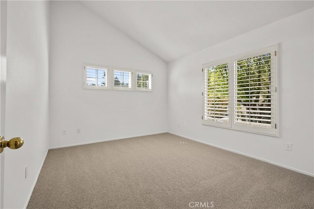 unfurnished room with vaulted ceiling and carpet flooring