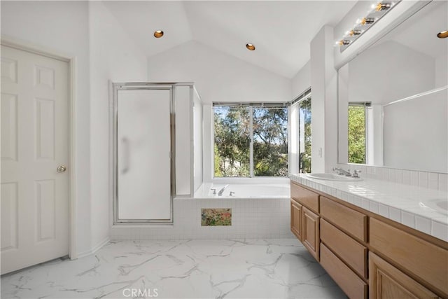 bathroom with plus walk in shower, lofted ceiling, and vanity