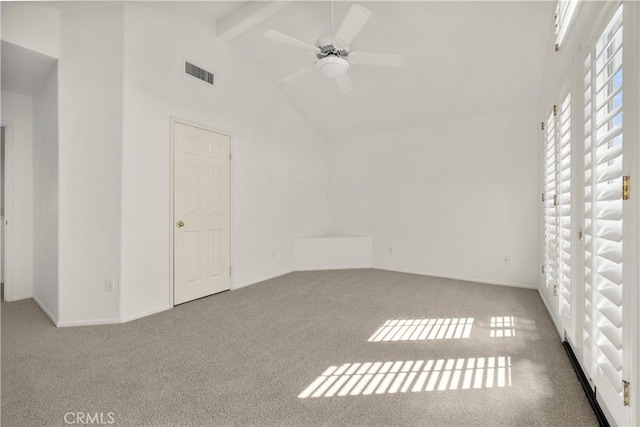 carpeted empty room with ceiling fan, high vaulted ceiling, and beam ceiling