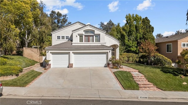 view of property with a garage and a front lawn