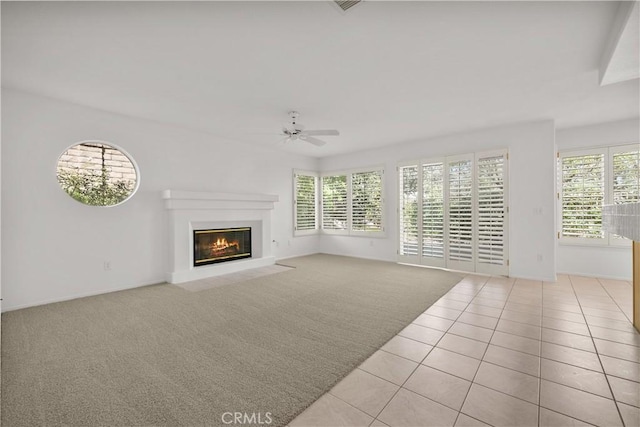 unfurnished living room with ceiling fan and light tile patterned flooring