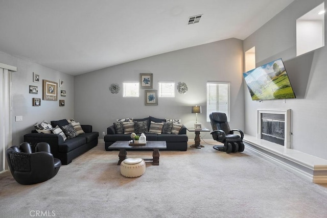 living room featuring carpet, lofted ceiling, and a wealth of natural light