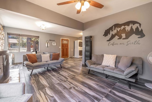 living room featuring hardwood / wood-style floors and ceiling fan