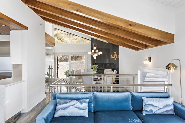 living room with high vaulted ceiling, dark hardwood / wood-style floors, beamed ceiling, and an inviting chandelier