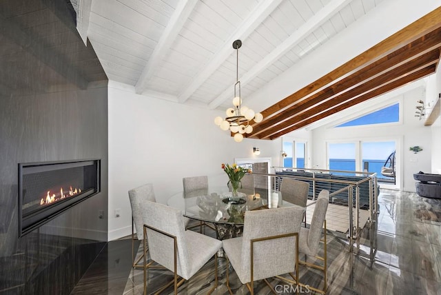 dining space featuring vaulted ceiling with beams, a water view, and an inviting chandelier