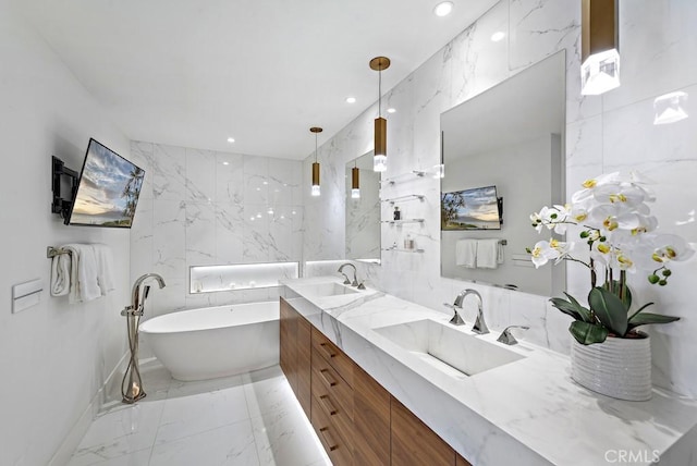 bathroom featuring a tub to relax in and vanity