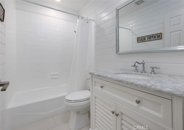 full bathroom featuring toilet, vanity, tile patterned flooring, and shower / bath combo with shower curtain