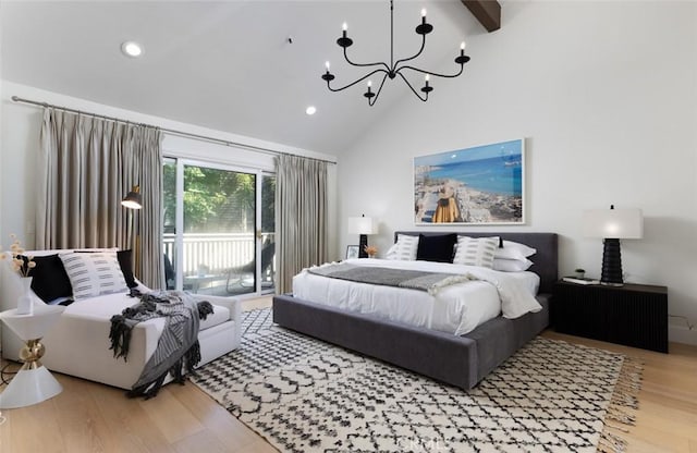 bedroom featuring high vaulted ceiling, access to exterior, hardwood / wood-style floors, and a notable chandelier