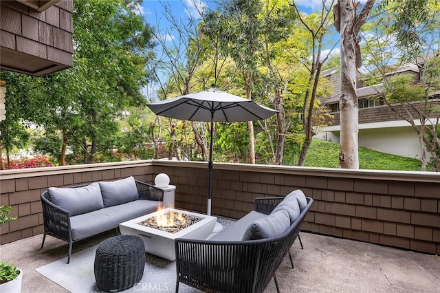 view of patio / terrace with an outdoor living space with a fire pit