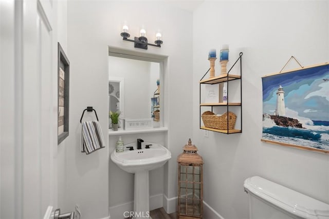 bathroom featuring hardwood / wood-style flooring, sink, and toilet