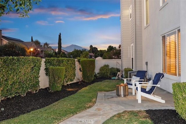 yard at dusk with a patio