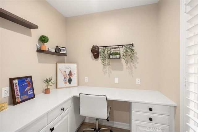 office area featuring hardwood / wood-style floors and built in desk