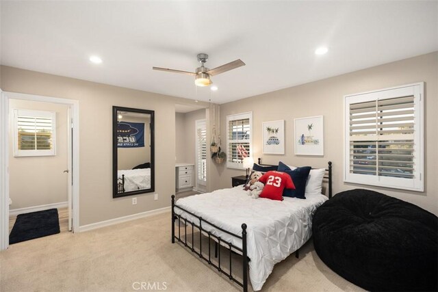 bedroom with ceiling fan and light carpet